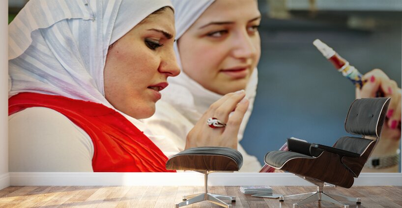 Young women enjoy hookah and talk on mobile phone in Aleppo Syri Wall Murals