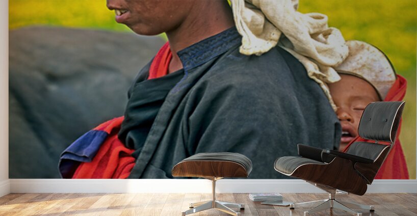 Woman carries son on her back in Myanmar fields Wall Murals