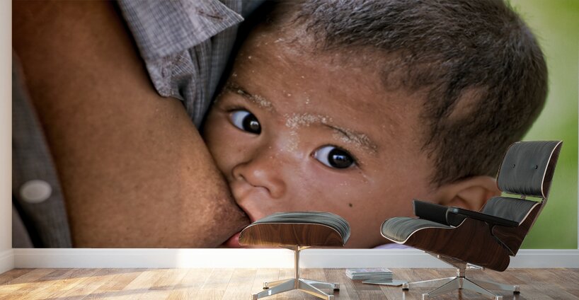 Feeding a baby in Myanmar during daytime hours Wall Murals