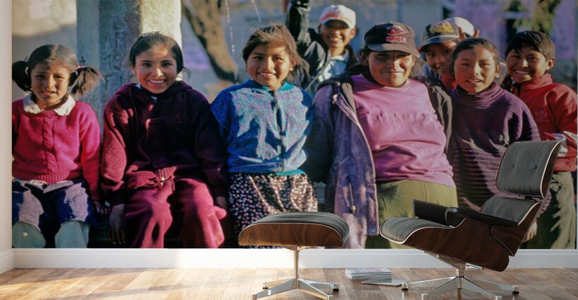 Smiling children and youth gather by a fountain. Wall Murals