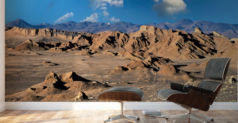 Rugged desert mountains under a clear blue sky with clouds. Wall Murals