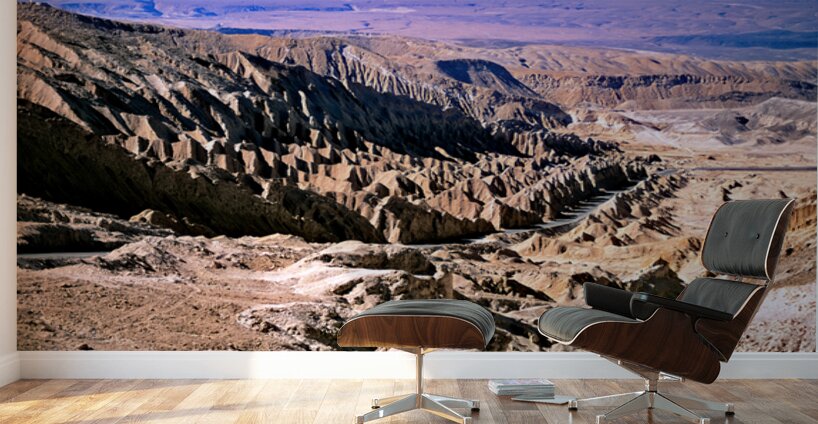 Eroded desert landscape with a road winding through mountains. Wall Murals
