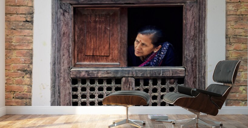 Woman in Kathmandu looks out from window in old building Wall Murals