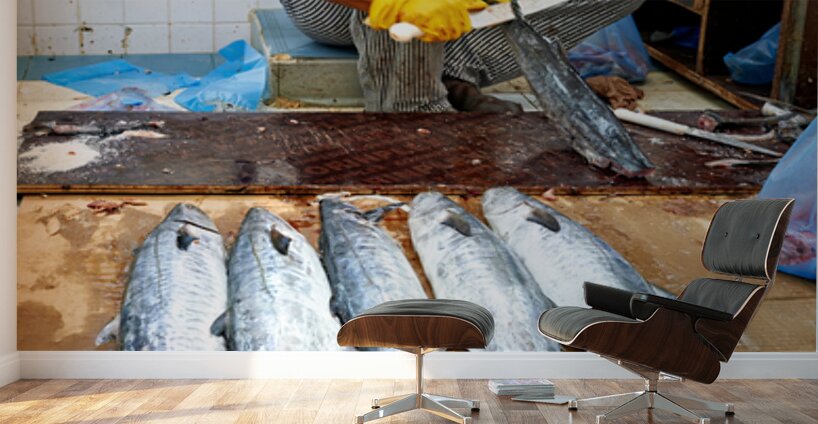 Fish seller prepares catch at Nizwa Oman fish market Wall Murals