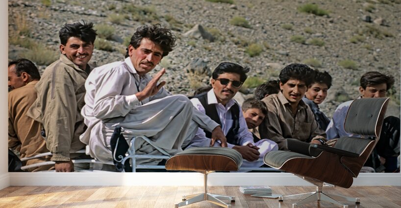 Group traveling on top of a van in Pakistans mountains Wall Murals