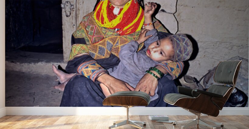 A woman holds her child in a Kalash village Wall Murals
