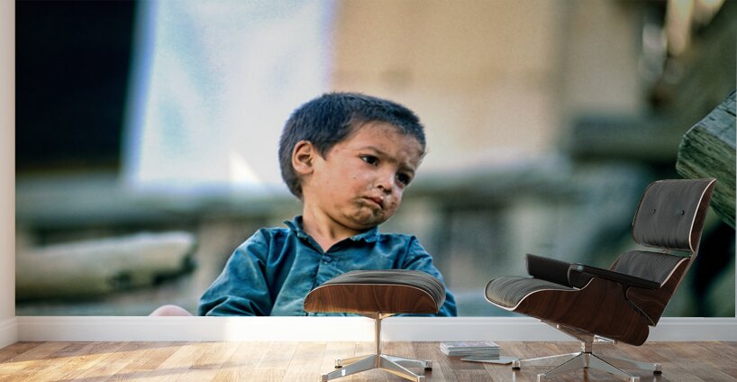 Sad boy sitting on stairs in Lahore Pakistan during the day Wall Murals