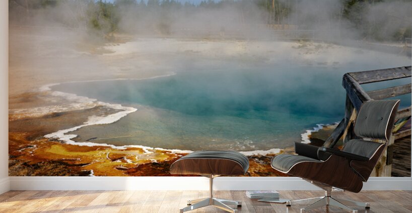 Steam rises from Abyss Pool as blue water reflects the surrounding landscape at Yellowstone National Park. Visitors explore the area nearby. Wall Murals