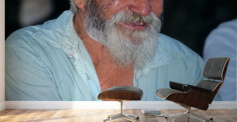 Elderly man smiles while sitting outdoors in Bukhara Uzbekistan Wall Murals