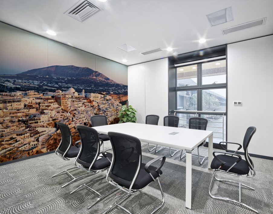 Santorini cliffside town at sunset with mountain backdrop. Wall Printing