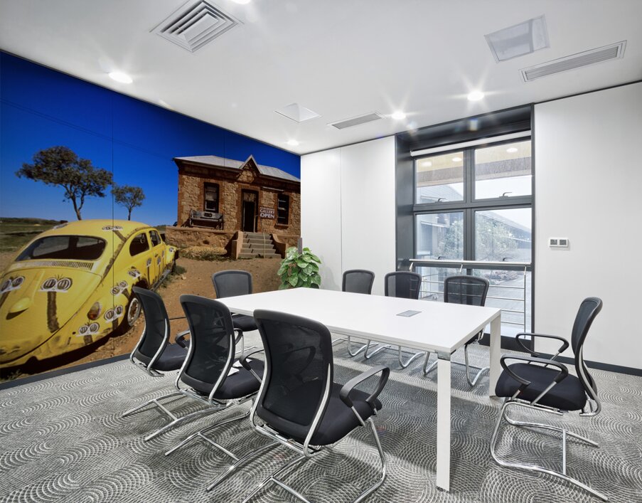 A painted yellow Beetle outside a rural stone gallery. Wall Printing