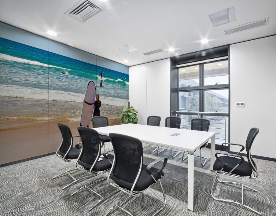 Surfer girl with surfboard on beach watching waves Wall Printing