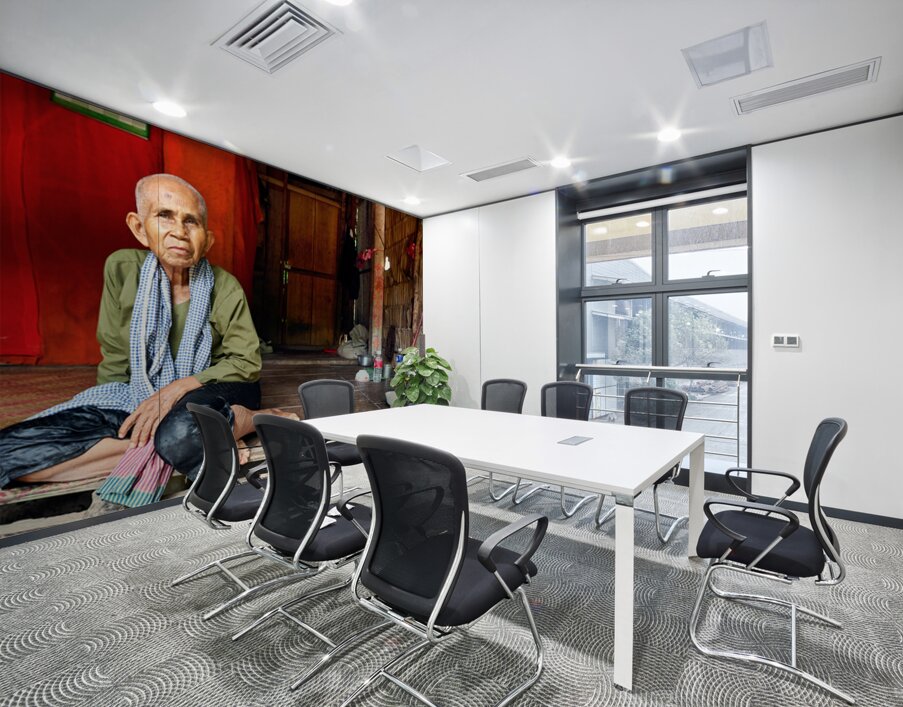 Elderly person sitting on floor in rustic dwelling. Wall Printing