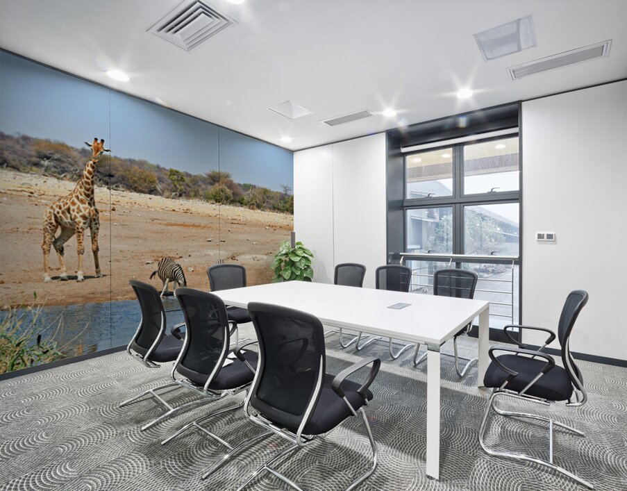 Giraffe and zebras drink water together at a waterhole in Namibi Wall Printing