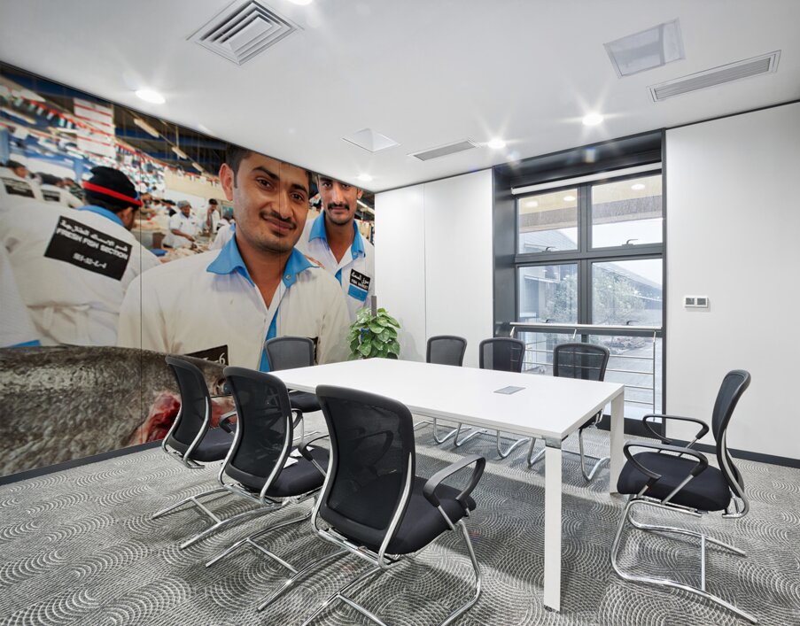Smiling fishmongers hold fresh fish at market in Dubai UAE Wall Printing