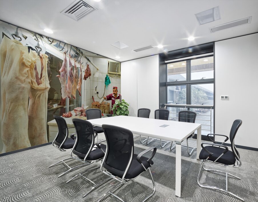 Butcher works in meat market in Dubai with hanging meat Wall Printing