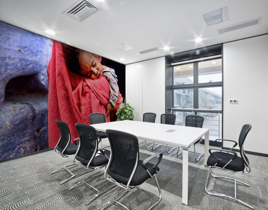 Mother carries sleeping child in India during daytime Wall Printing
