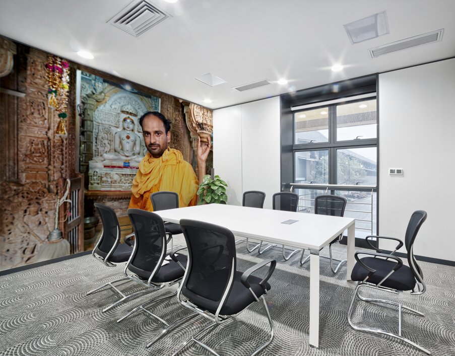Hindu monk stands near statue in Jaisalmer Jain temple Wall Printing