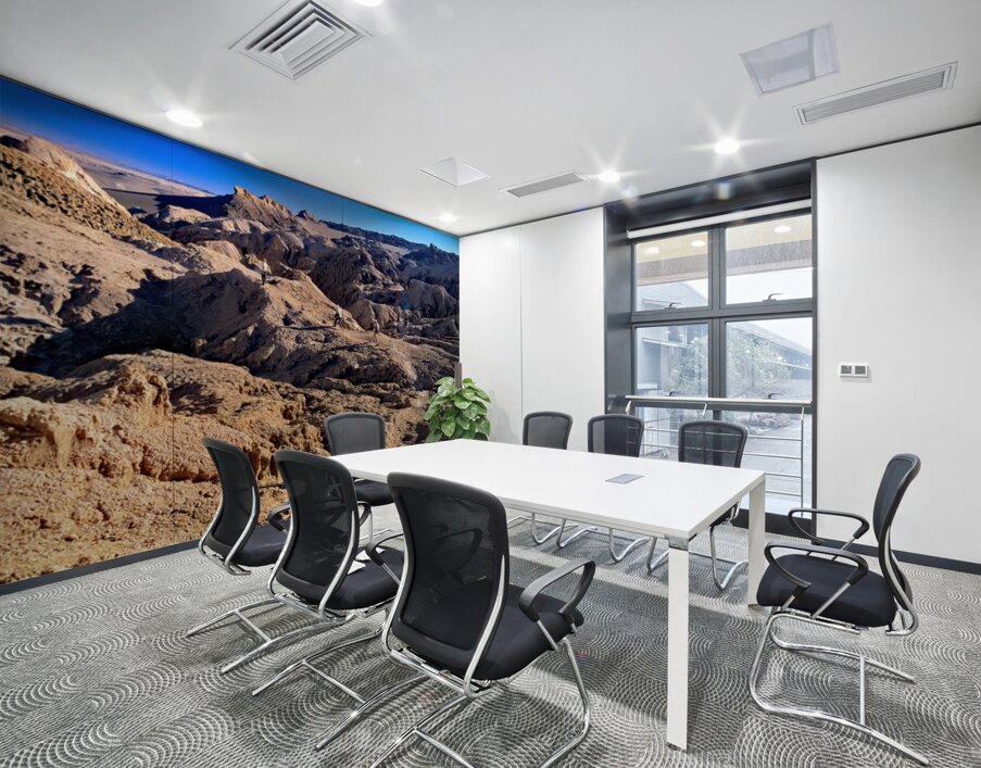Hikers traverse a vast arid rocky desert landscape. Wall Printing