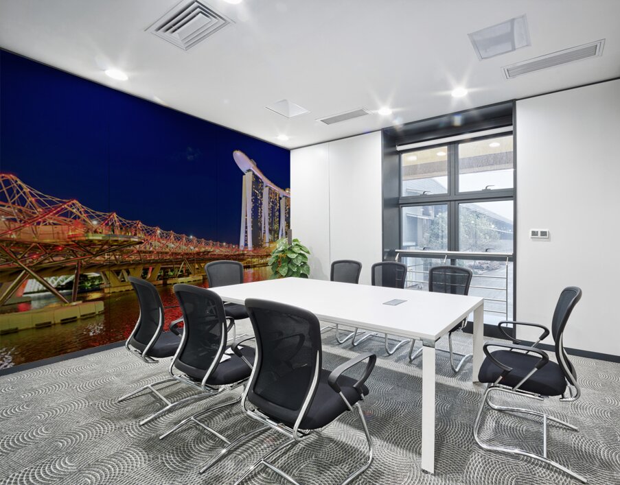 People walk across the Helix Bridge as the Marina Bay Sands Hotel shines at sunset. The sky turns orange and lights reflect in the water. Wall Printing
