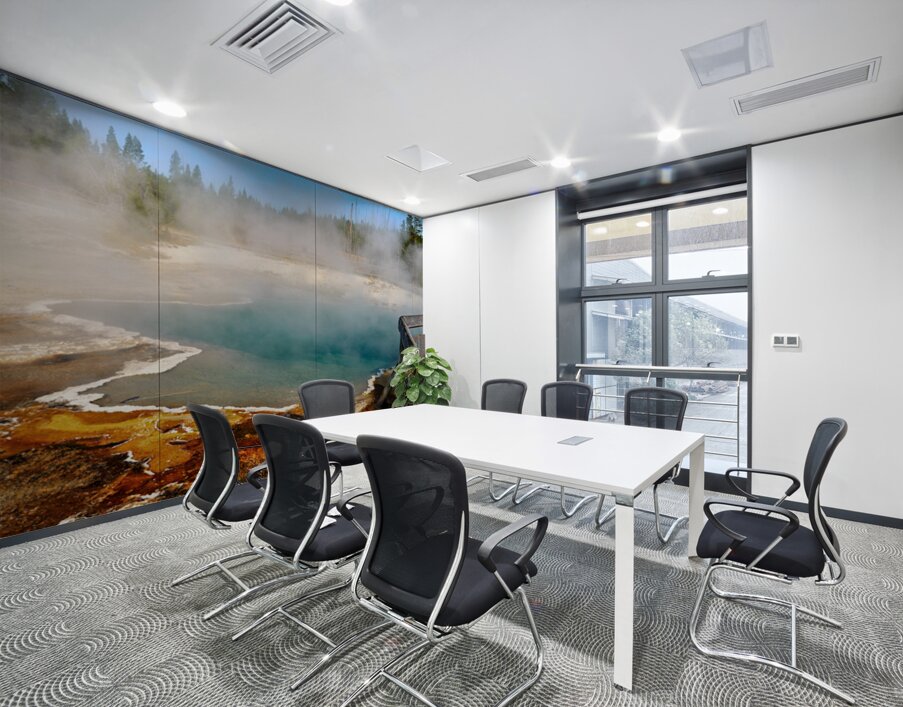 Steam rises from Abyss Pool as blue water reflects the surrounding landscape at Yellowstone National Park. Visitors explore the area nearby. Wall Printing