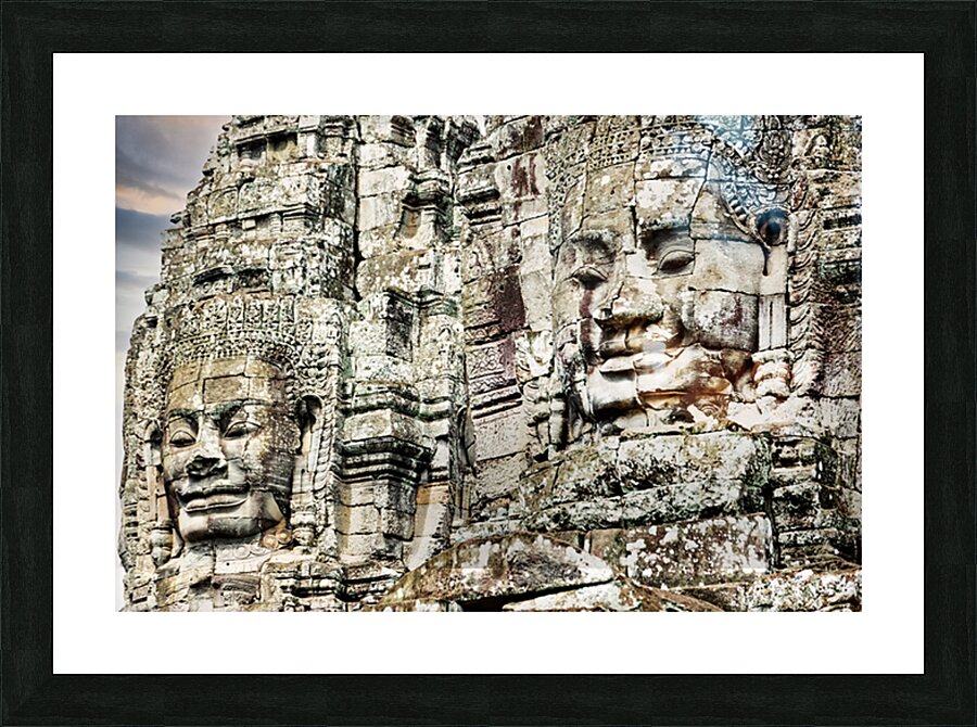 Serene stone faces adorn ancient Cambodian temple. Picture Frame print