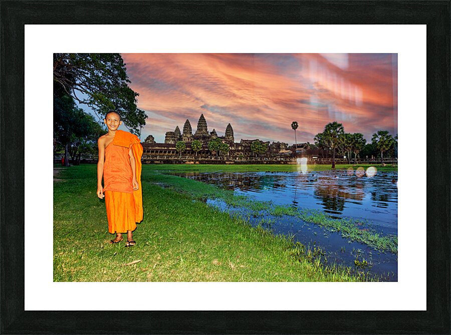Monk stands by pond with Angkor Wat and sunset sky. Picture Frame print