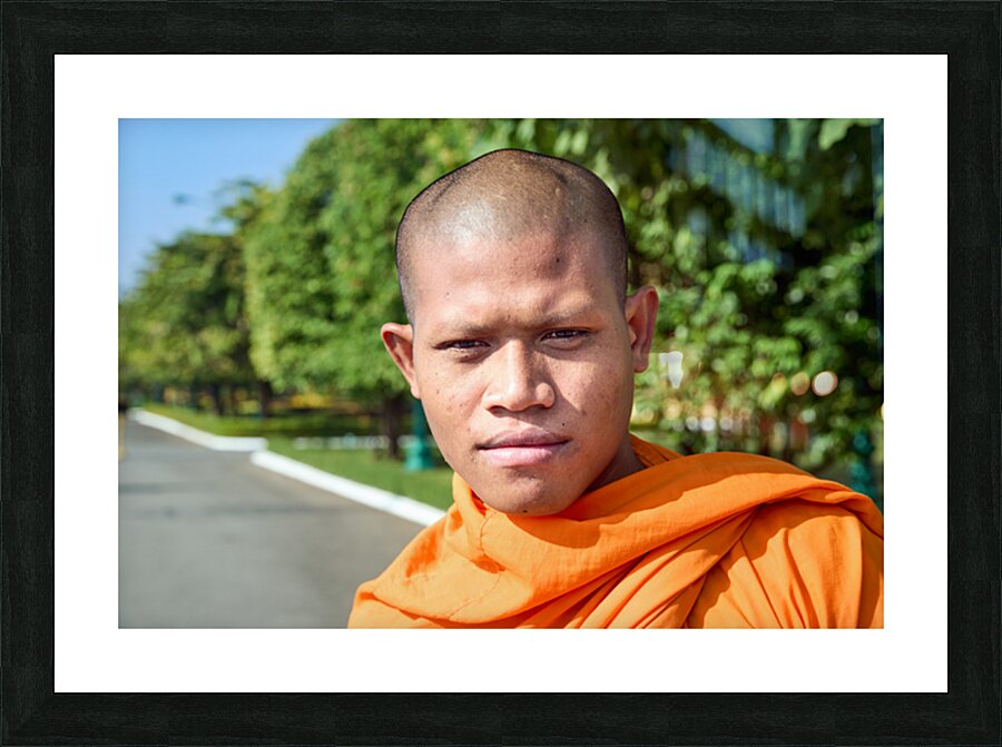 Portrait of a young Buddhist monk in orange robe. Picture Frame print