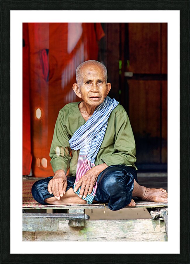 Elderly person in traditional clothing sitting calmly. Picture Frame print