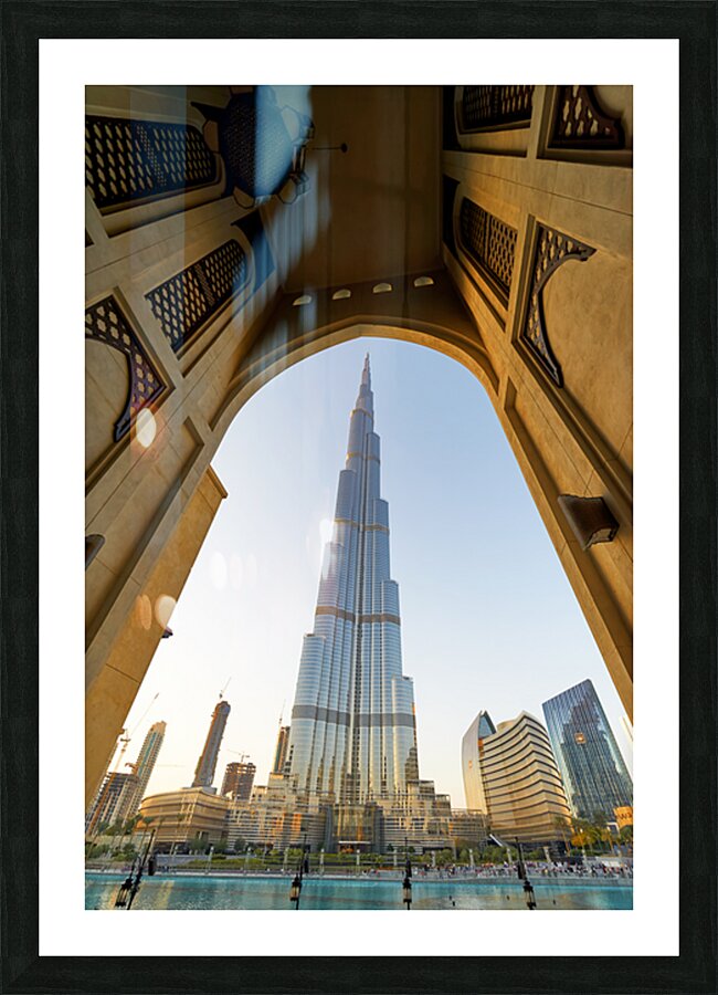 Burj Khalifa seen through ornate arch in Dubai cityscape Picture Frame print
