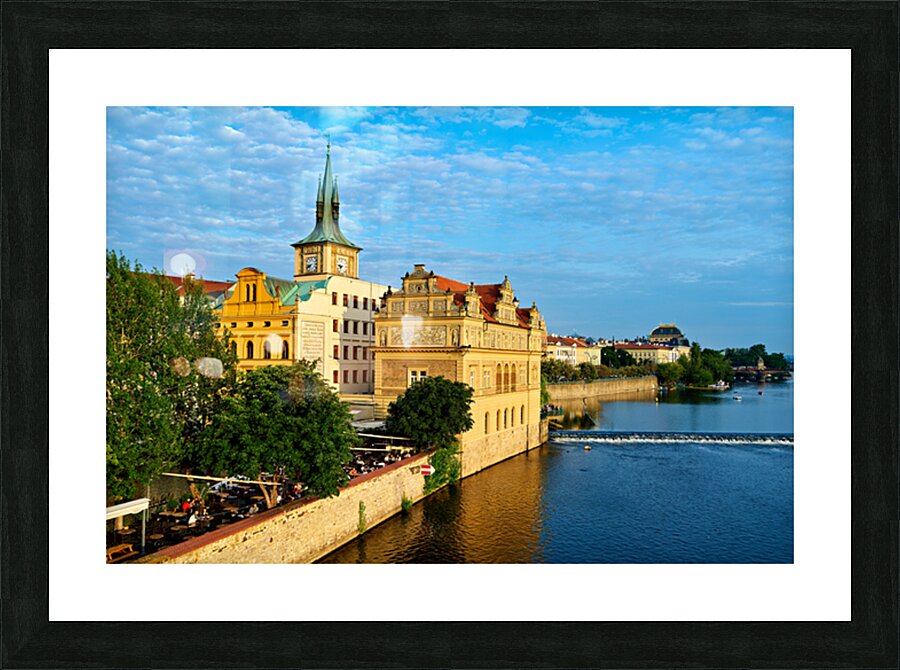 Pragues Vltava riverfront with historic architecture and lively Picture Frame print