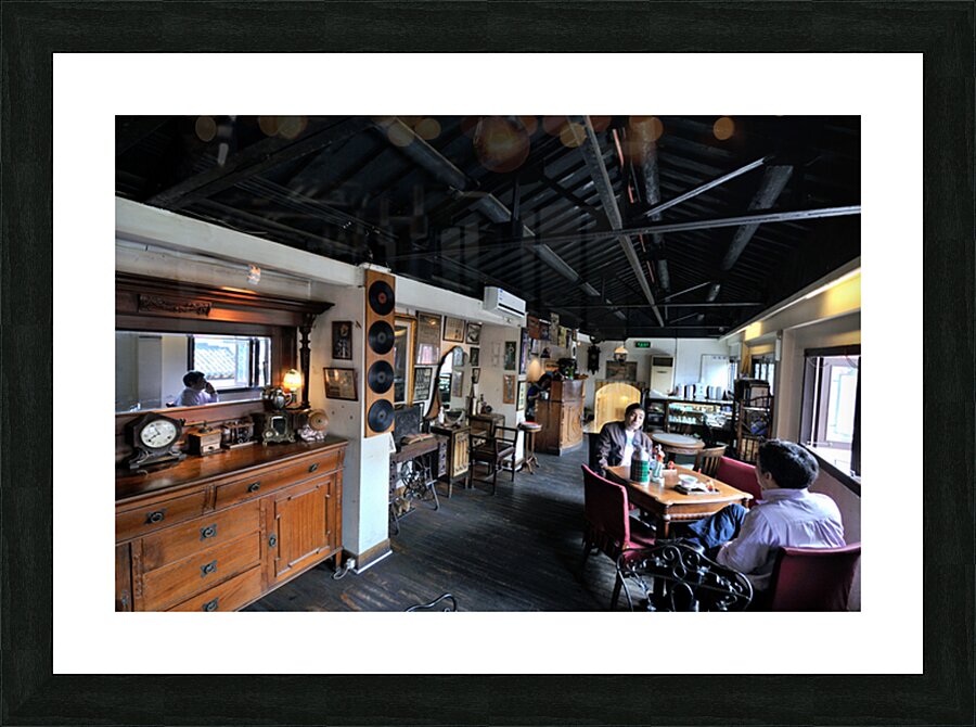 Customers enjoy drinks and food in a vintage cafe in Shanghai Picture Frame print