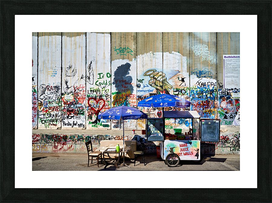 Separation wall in Bethlehem with a juice stand near graffiti Picture Frame print