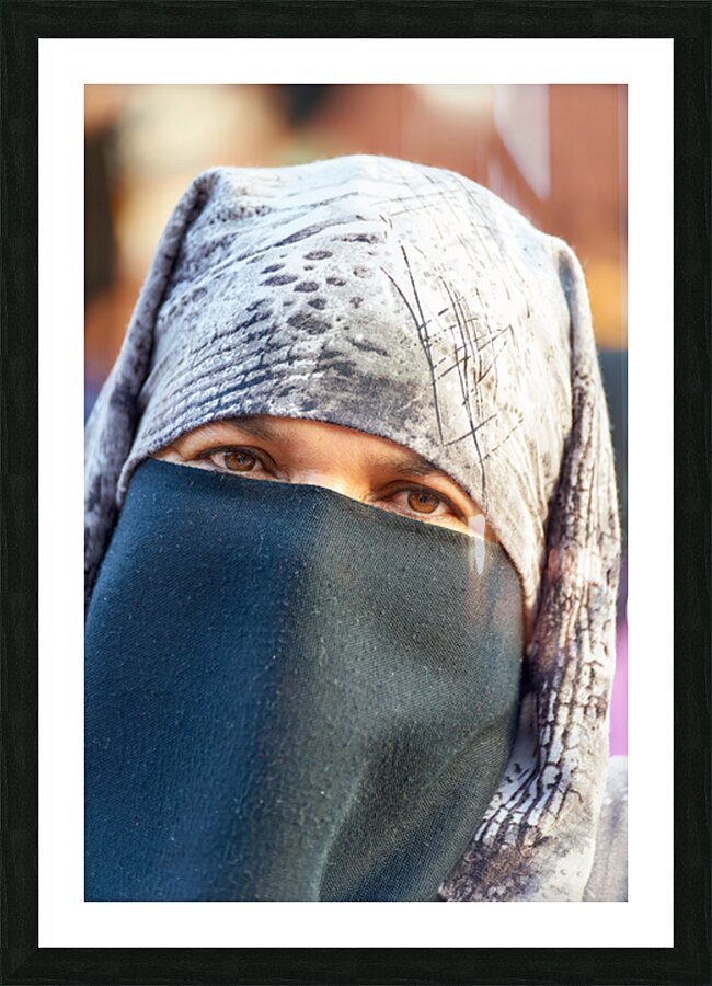 Veiled Moroccan woman in Marrakesh market on a sunny day Picture Frame print