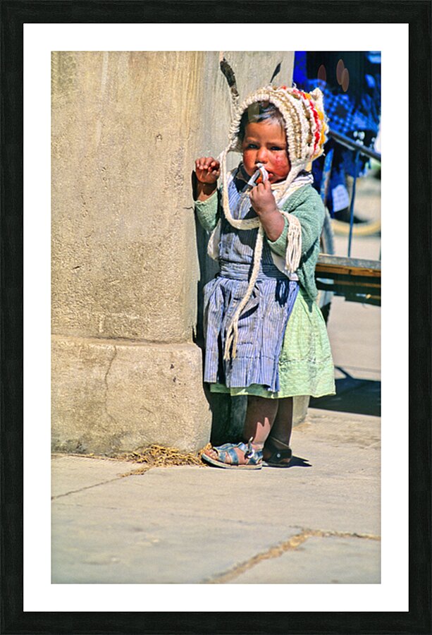 Young child in traditional attire appears to be smoking. Picture Frame print