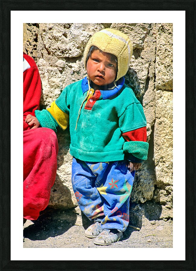 Indigenous child in colorful clothes and yellow hat outdoors. Picture Frame print