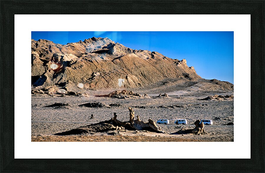 Arid mountain landscape with vans on a desert road. Picture Frame print