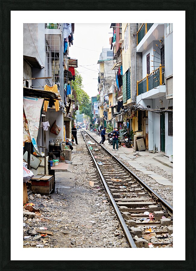 People walk along railway tracks in Ho Chi Minh City Vietnam Picture Frame print
