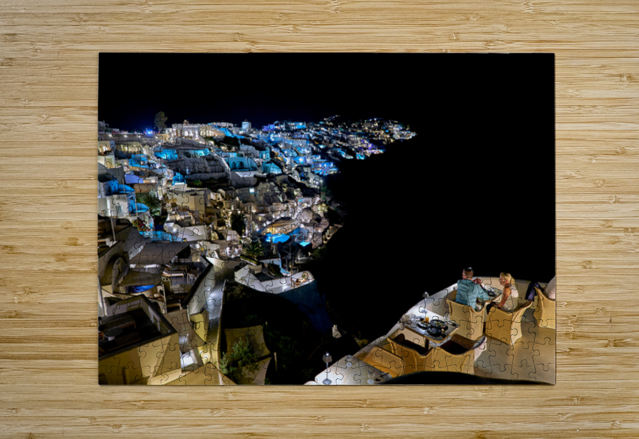 Illuminated cliffside town at night couple enjoying dinner. Marco Brivio Puzzle printing