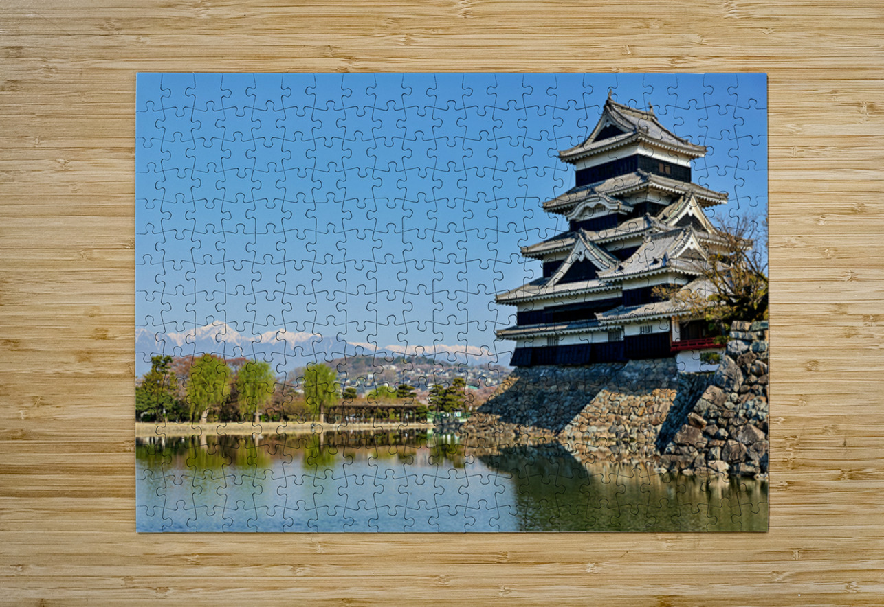 Matsumoto Castle stands beside water with mountains in the dista Marco Brivio Puzzle printing