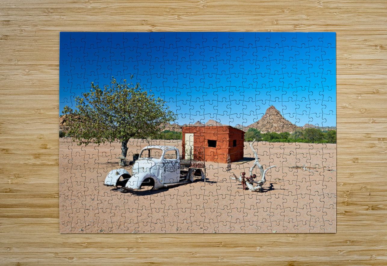 Classic car wreck in Namibias desert landscape near a structure Marco Brivio Puzzle printing