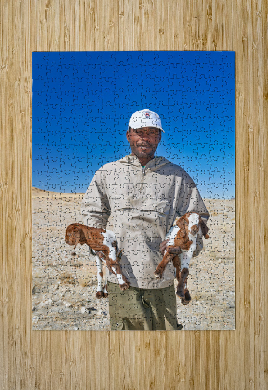 Shepherd holds his young goats in Namibia under bright blue sky Marco Brivio Puzzle printing