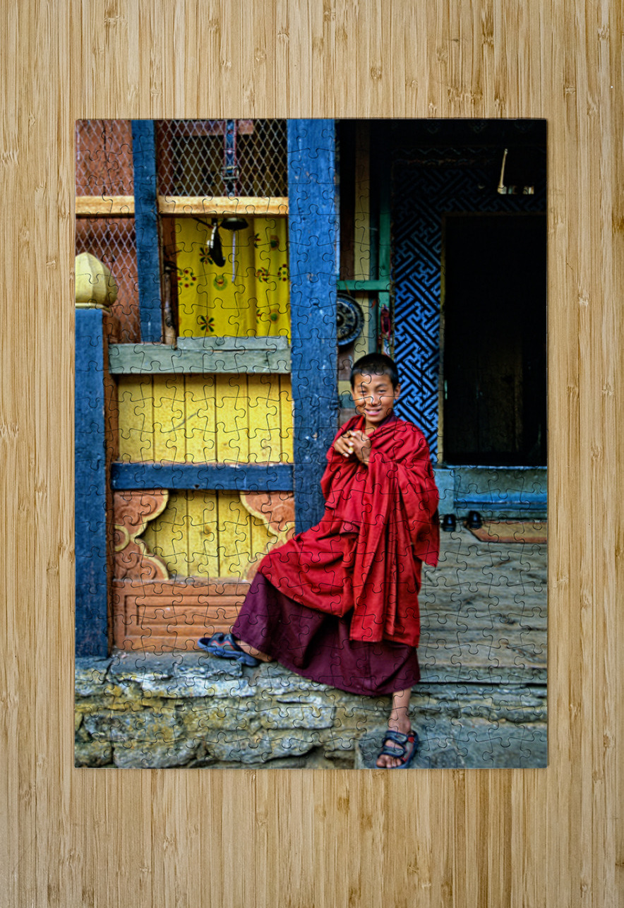 Smiling young monk in red robes at colorful traditional building Marco Brivio Puzzle printing