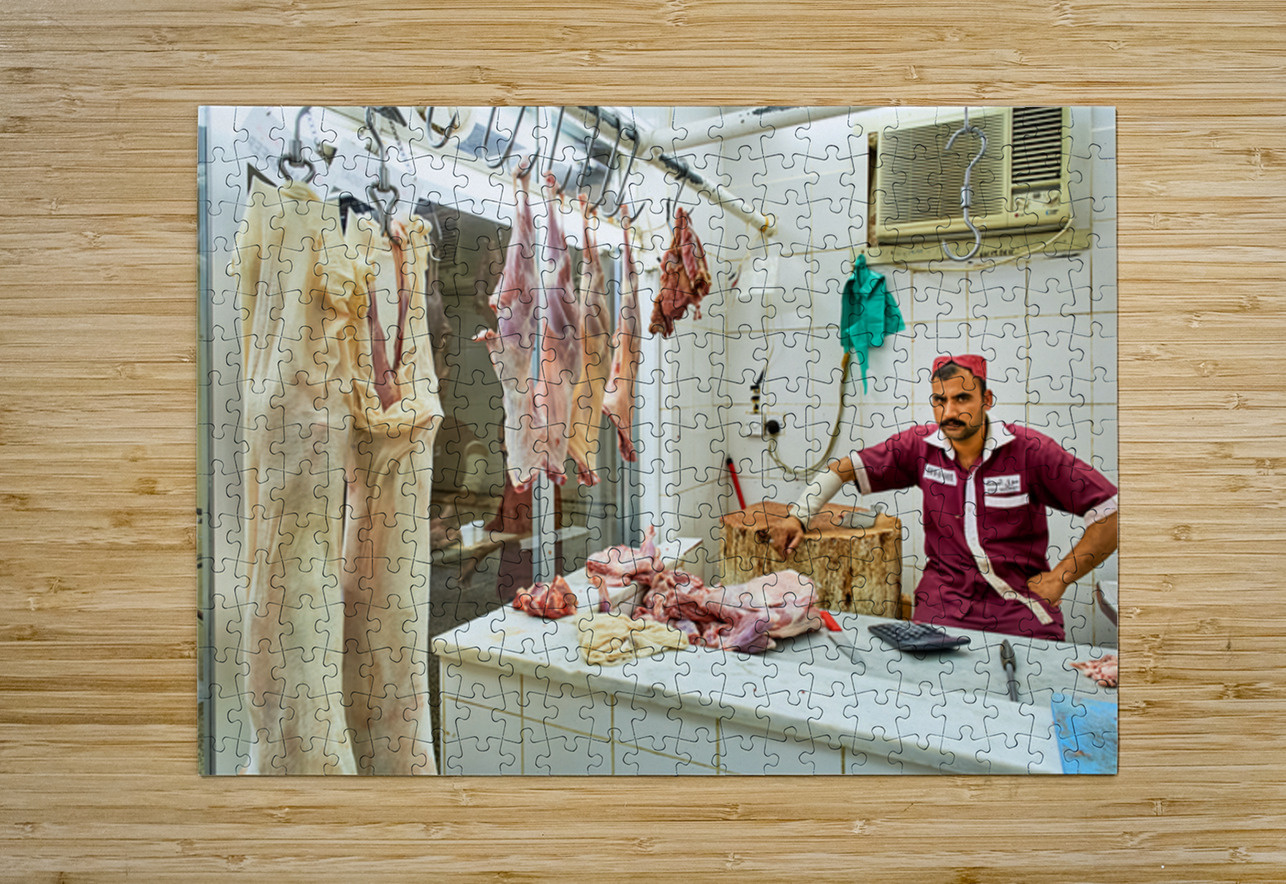 Butcher works in meat market in Dubai with hanging meat Marco Brivio Puzzle printing
