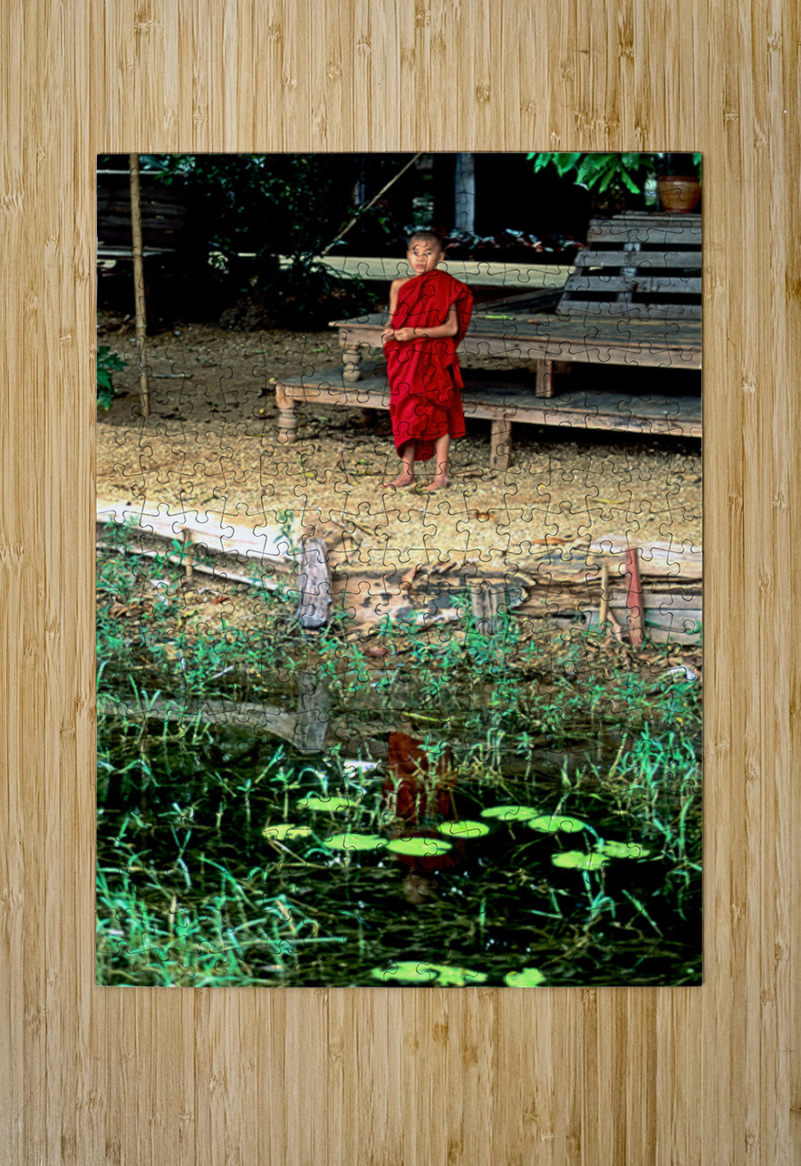 Young monk stands by water in Myanmar during daytime Marco Brivio Puzzle printing
