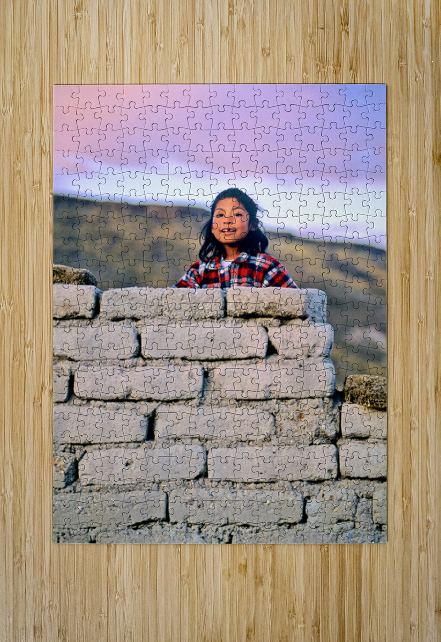 Young girl smiles over stone wall at sunset. Marco Brivio Puzzle printing