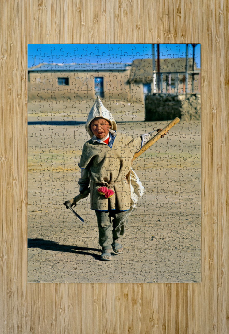 Indigenous boy with tools walks through a dusty village. Marco Brivio Puzzle printing