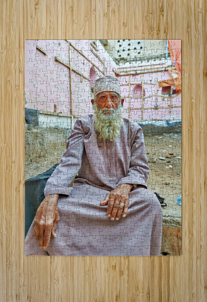 Old man sitting in a historical site in Muscat Oman Marco Brivio Puzzle printing