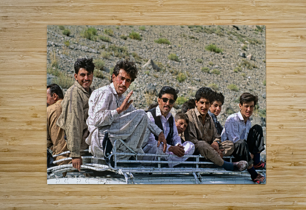Group traveling on top of a van in Pakistans mountains Marco Brivio Puzzle printing