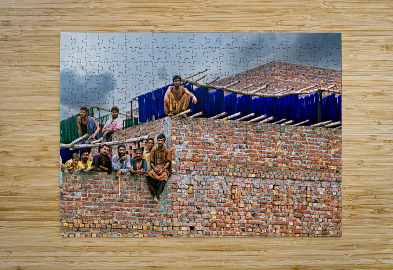 Workers rest during break time at a construction site in Lahore Marco Brivio Puzzle printing